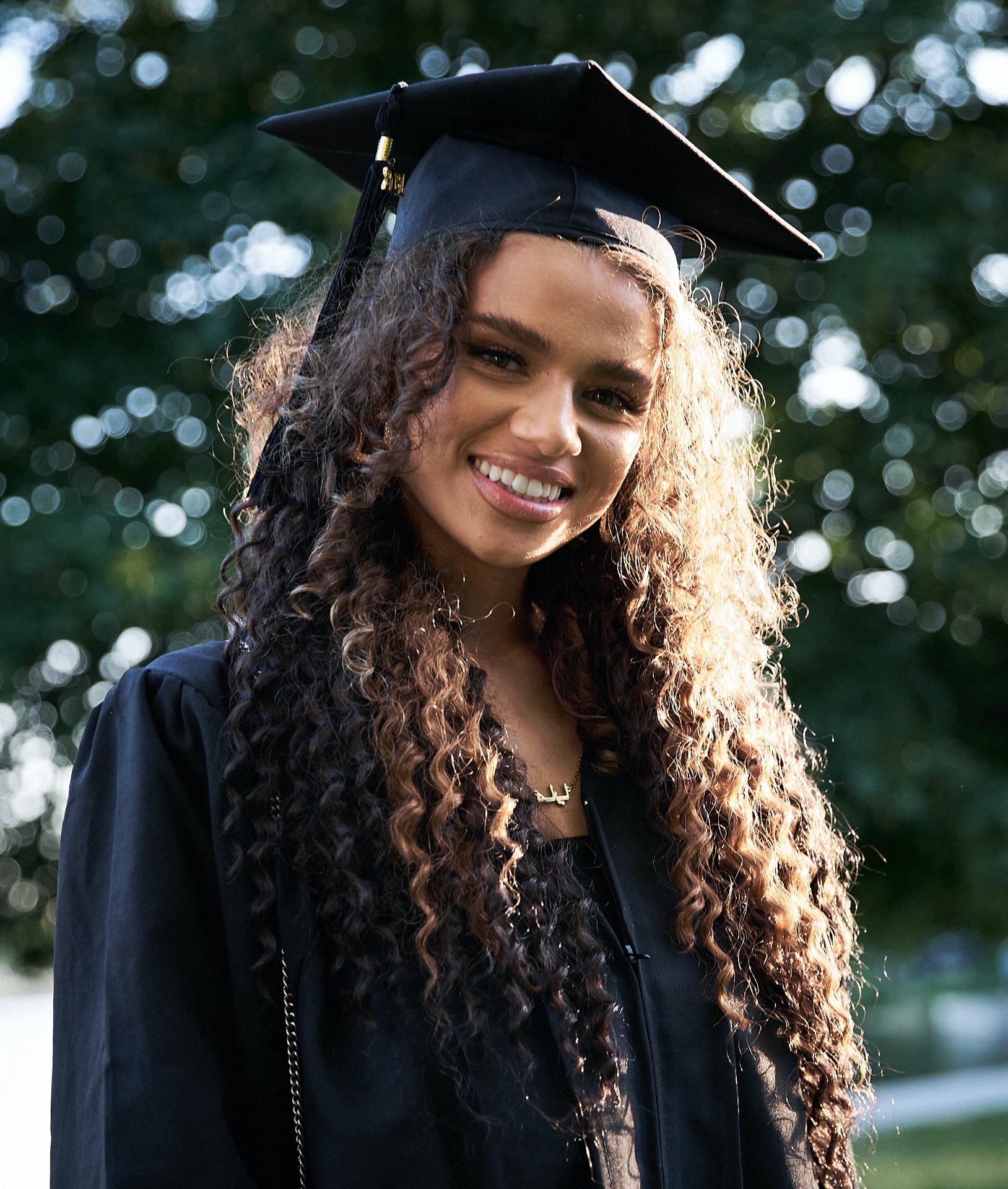 Graduating student smiling in cap and gown